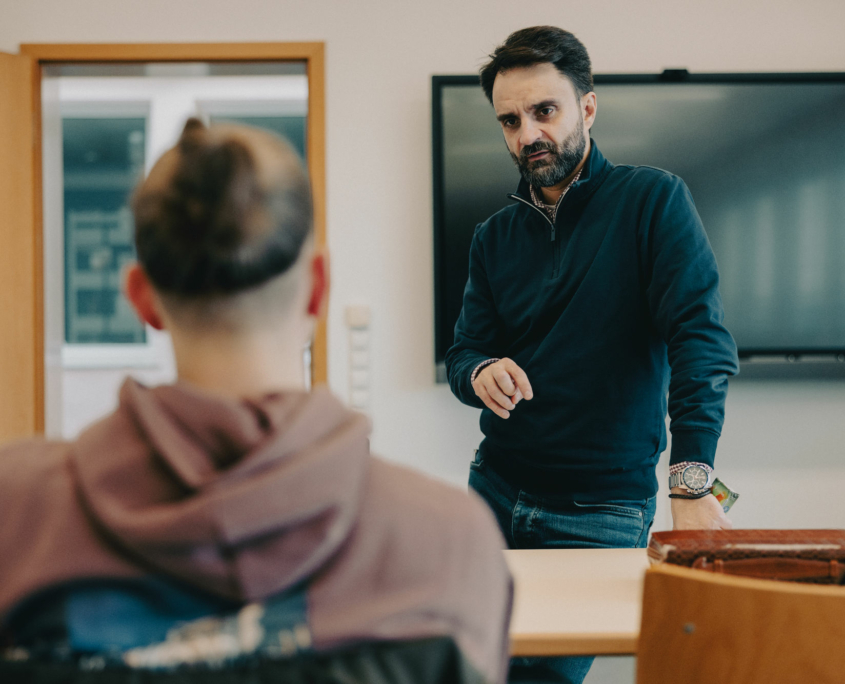 The President of the European Theological Seminary is being asked a question in the classroom by a student.